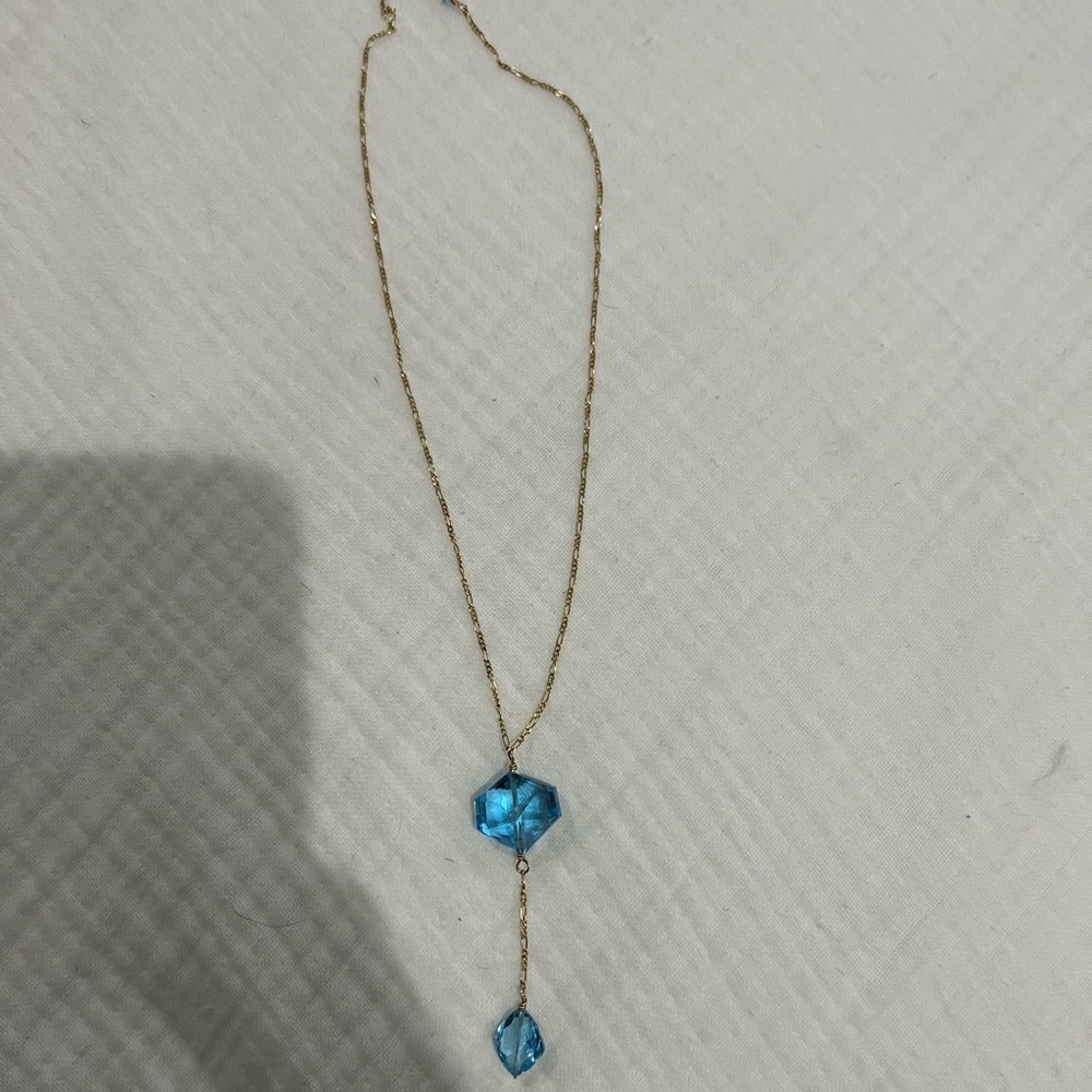 Gold necklace with blue beading drop detail